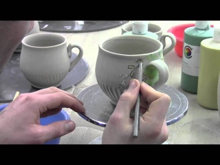 Ben Carter Decorating a mug with under glazes and sgraffito