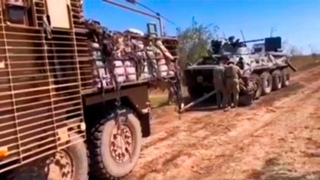 Ukrainian Wolfhound MRAP (From United Kingdom) Towing A Newly Captured Russian BTR-80