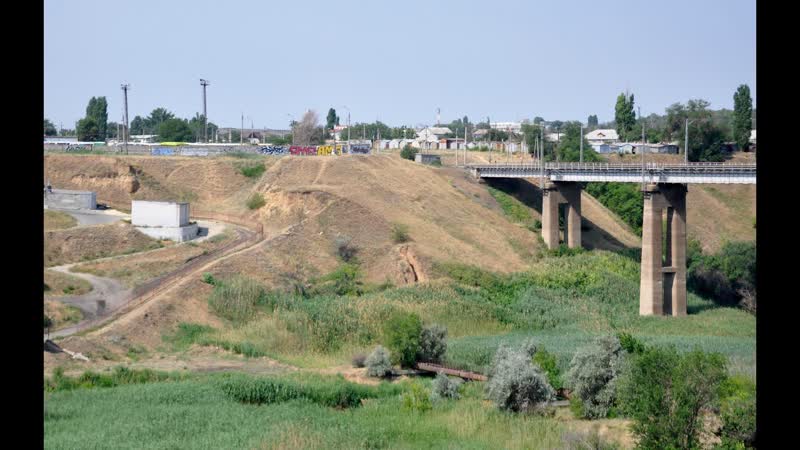 Passing a railway bridge and an overpass across the Sukchaya Mechetka river in the city of
